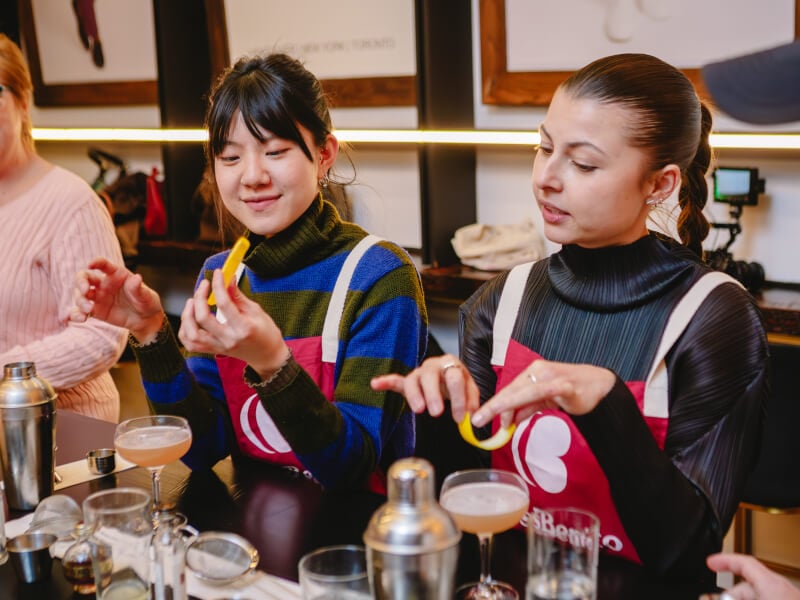 Two people side by side at a cocktail making class
